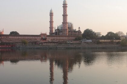 Taj-ul-Masajid , the biggest mosque in India, with its grand domes and minarets, reflected in the adjacent lake