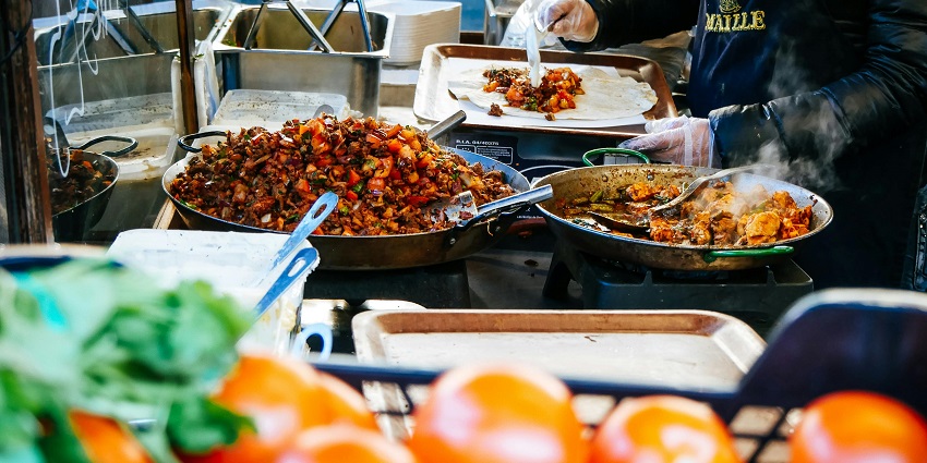 Several dishes being cooked and served hot for the customers craving street food.