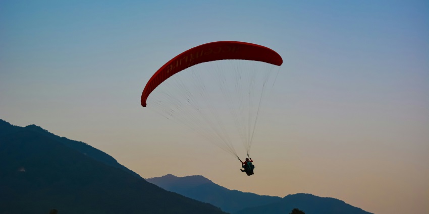 A person soaring high in Bir Billing, one of the best spots for paragliding in Manali.