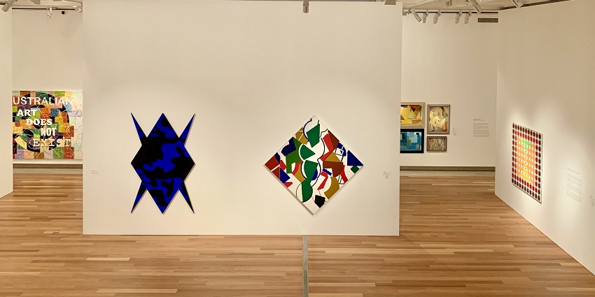 A view of exquisite paintings and sculptures hung on a wall in a tourist attraction.