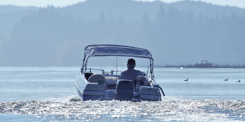 A surreal scene of a man boating on the beautiful ocean in Chilka Wildlife Sanctuary.