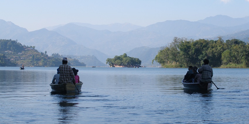 Scenic view of boats sailing on the serene waters of Phewa lake, an ideal place for nature lovers