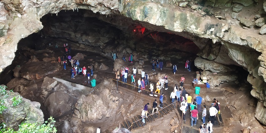 Image of Borra Caves people entering and exploring the old huge rocks during day time
