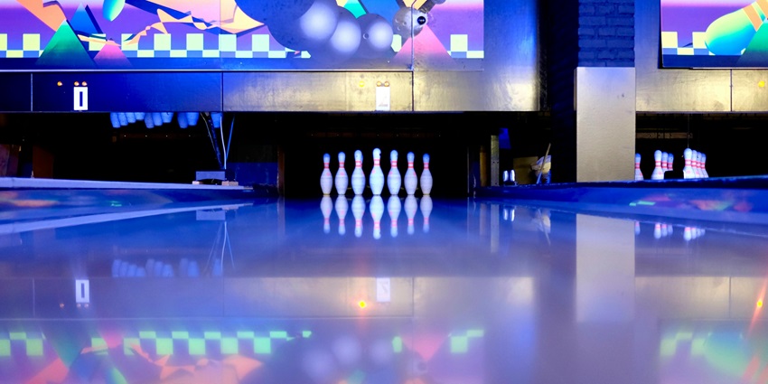 Image of Bowling Pins Set on Ground with vibrant lights decorated and flashing on the floor