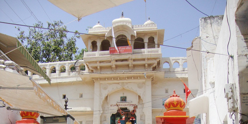 The temple has carved images of gods and decorative patterns on its stone walls.