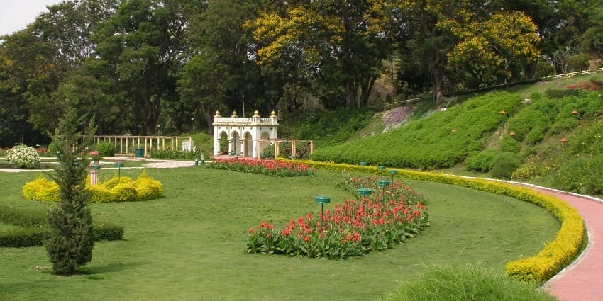 The garden features various plants, trees and flowers, perfect for spending relaxing time