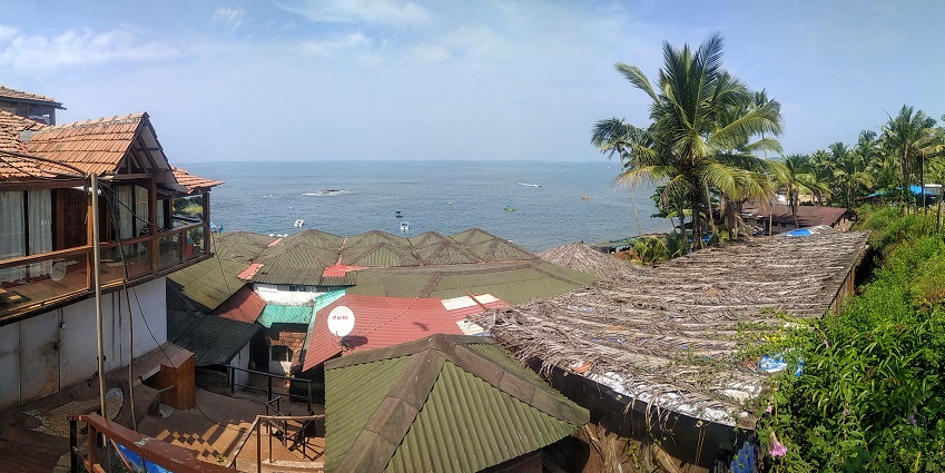 A picture of a beachside shack in Goa with trees in the background