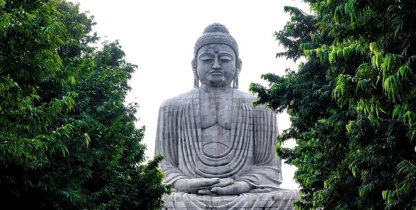 An image of the iconic Buddha Statue at a temple in Gaya, Bihar, with devotees gathered.