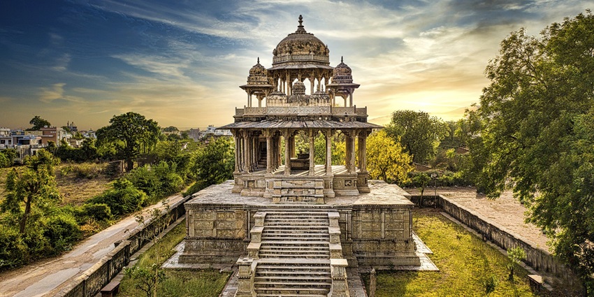 Picturesque view of stairs leading to the cenotaph, surrounded by lush landscapes with clear blue sky in the backdrop