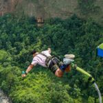 View of an Adventurer bungee jumping in Nepal, falling from the top with a hanging rope.