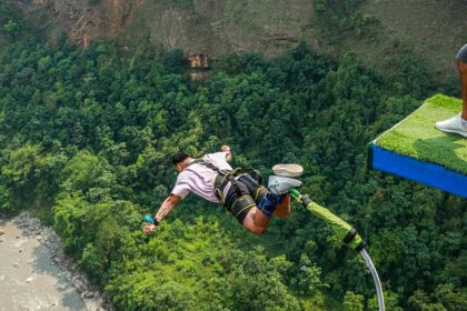 View of an Adventurer bungee jumping in Nepal, falling from the top with a hanging rope.