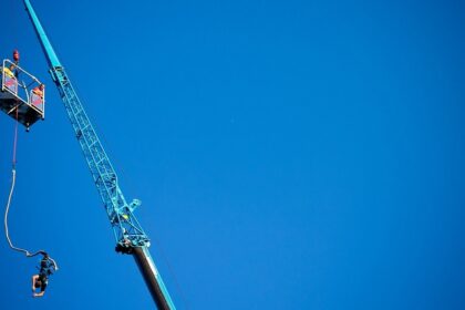 A person leaps off a platform into the air in Sentosa, a place for bungee jumping in Singapore.