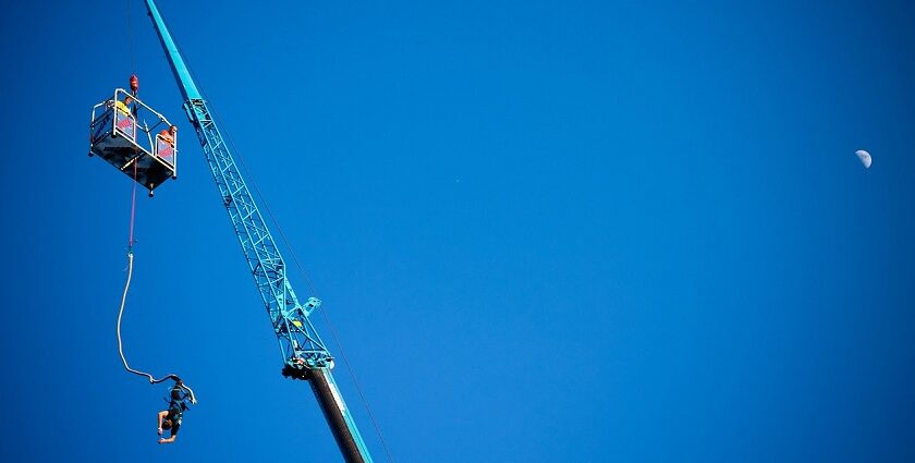 A person leaps off a platform into the air in Sentosa, a place for bungee jumping in Singapore.