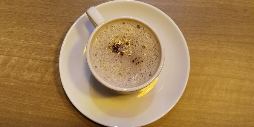 Snapshot of the Coffee in the ceramic cup on the table in the Cafe—Best food in rohini