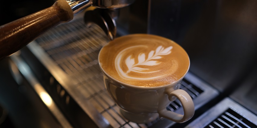 A picture of a cup of coffee with Latte art, served at a cafe in Calangute