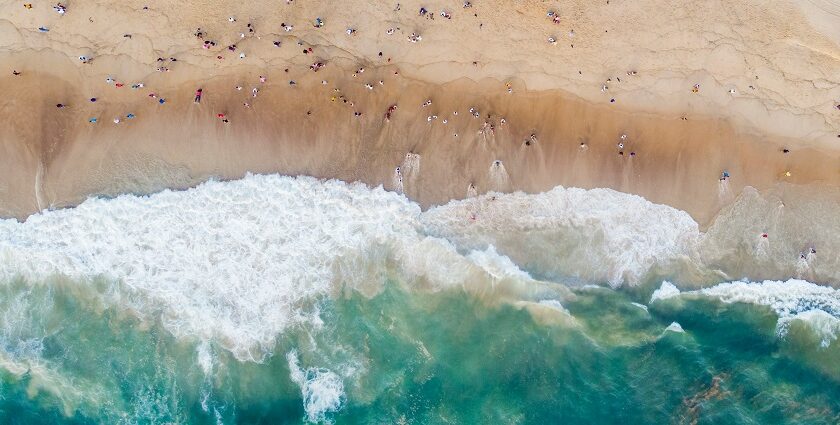 A bird’s eye view of the turquoise blue waters meeting the golden pristine sands.