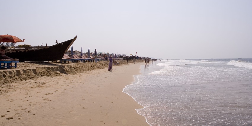A picture of Calangute Beach with boats on the golden sand and scenic views of the sea
