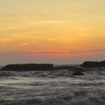 A beautiful sunset over Calangute Beach, with vibrant colors reflecting on the water.