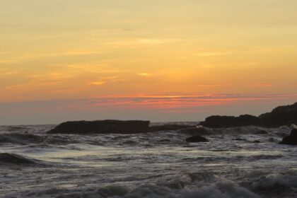 A beautiful sunset over Calangute Beach, with vibrant colors reflecting on the water.