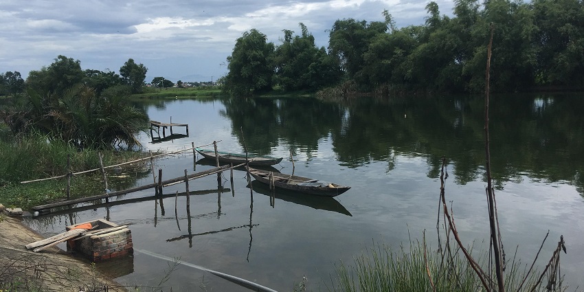 Scenic Thu Bon River arm on Cam Kim Island, offering serene views; a key Hoi An tourist place.