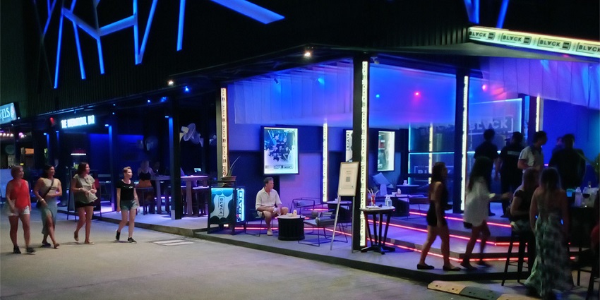The well-lit entrance of a club in Goa near the Baga beach during nighttime
