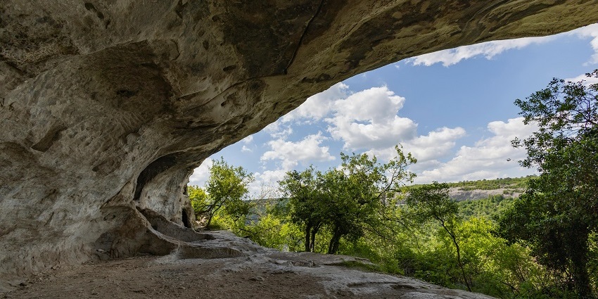A captivating view of a cave entrance, showcasing its rugged walls and mysterious depths.