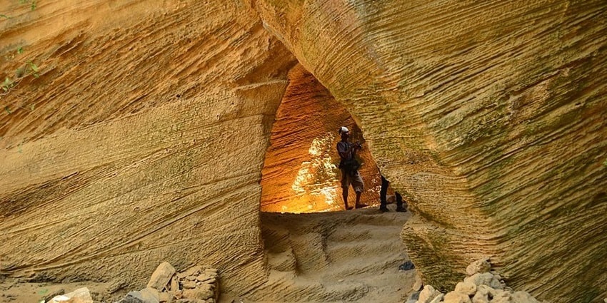 Bright daylight reveals the beautiful rock formations and serene waters of Naida Caves.