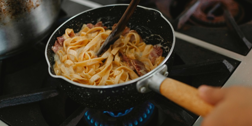 Image of a restaurant making noodles in a pot with delectable toppings and noodles texture look