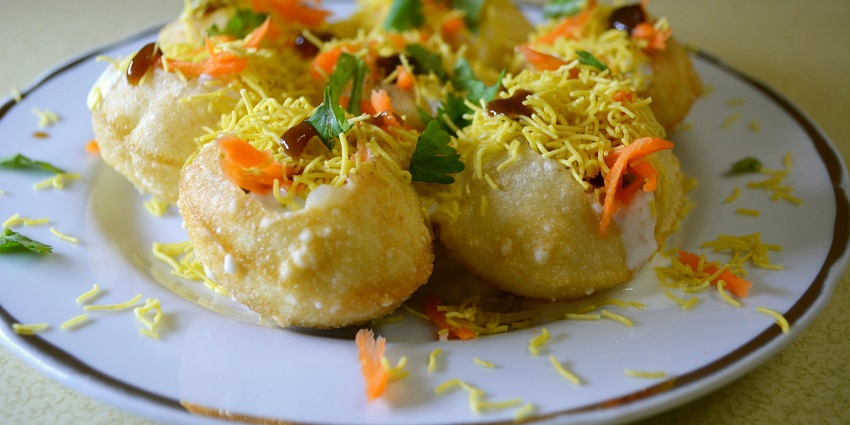 Chaat served with mint and tamarind chutney and sprinkled with curd and sev on the top