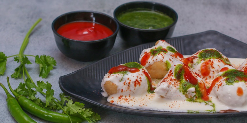 Dahi Bara with Mint Chutney and Tomato Chutney served on a plater at the Bikanervala