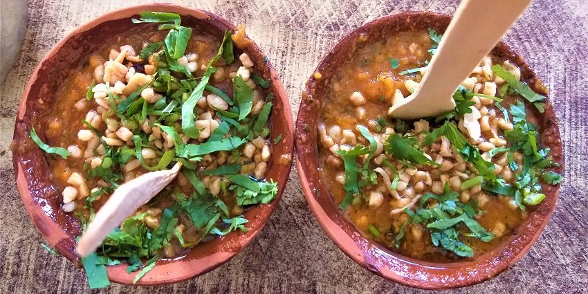 A vibrant bowl of tamatar chaat, featuring diced tomatoes, spices, and garnishes