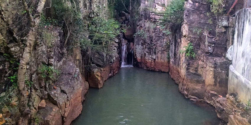 A scenic view of Chakra Teertham Waterfall featuring shimmering waters and greenery.