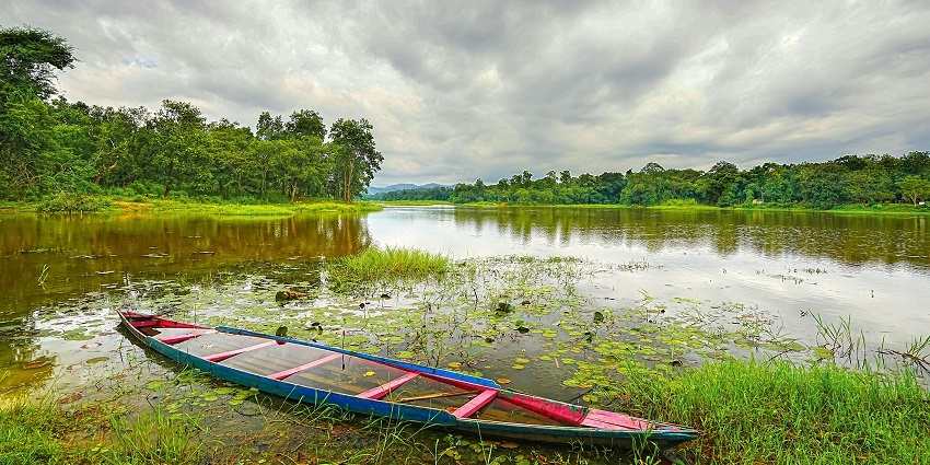 Chandubi Lake, a serene picnic spot near Guwahati, surrounded by natural beauty and forests.