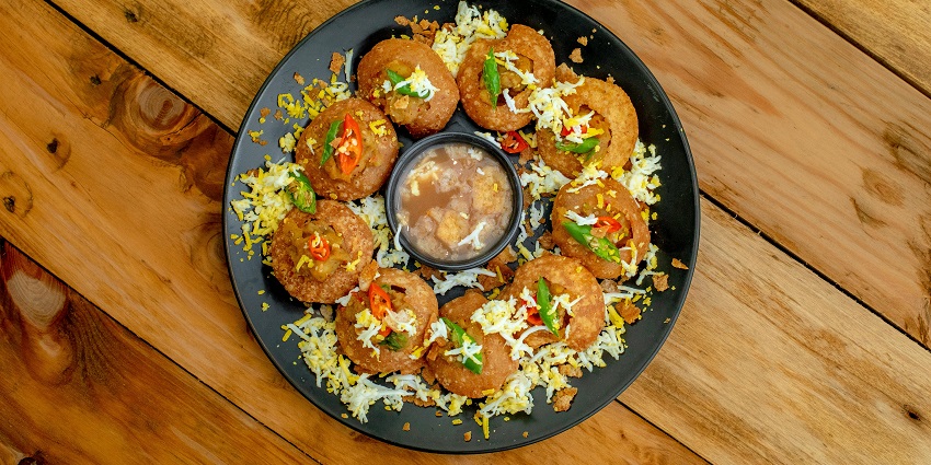 Chatkazz Corner with a vibrant display of Chaats and snacks including pani puris.