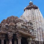 Chaturbhuj Temple with detailed stone carvings and a tall spire showcasing ancient architecture.