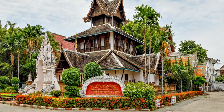 A picture of a traditionally built museum in Chiang Mai with lush greenery all around