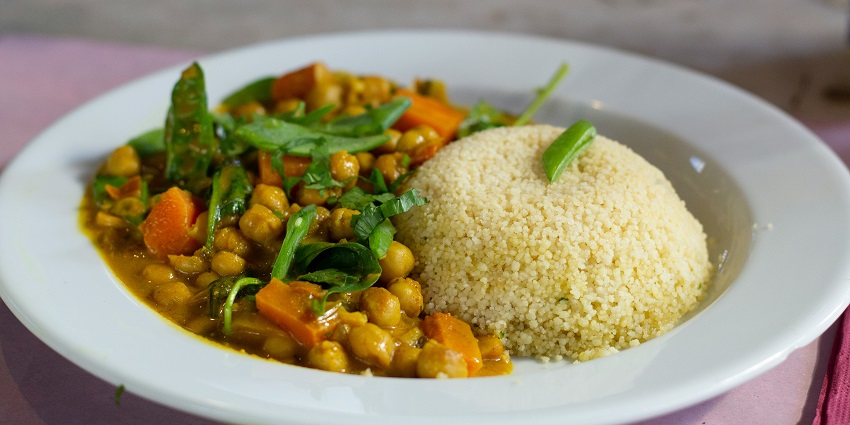 raditional Naga meal served on a leaf, featuring rice, vegetables, and meat, showcasing Naga cuisine.