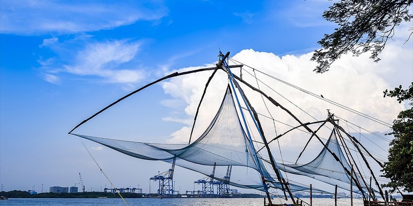Image of Chinese Fishing Nets with blue sky and white clouds in background at Fort Kochi, Kerala