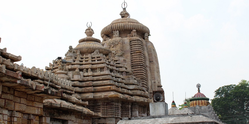 The temple features stone structure, typical Odia architecture, and a peaceful environment.