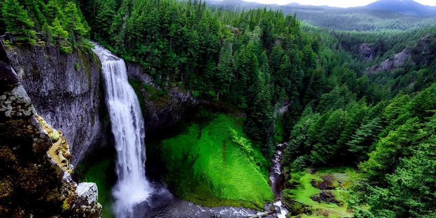 An eye-catching waterfall beside Ushakothi Wildlife Sanctuary surrounded by greenery.