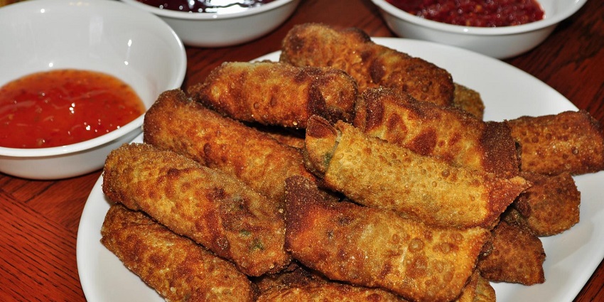 Crispy egg rolls served with spicy chutney and ketchup offering a blast to spicy food lovers