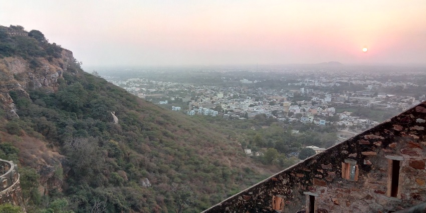 View of Chittorgarh city, featuring historic forts, temples, and lush green surroundings