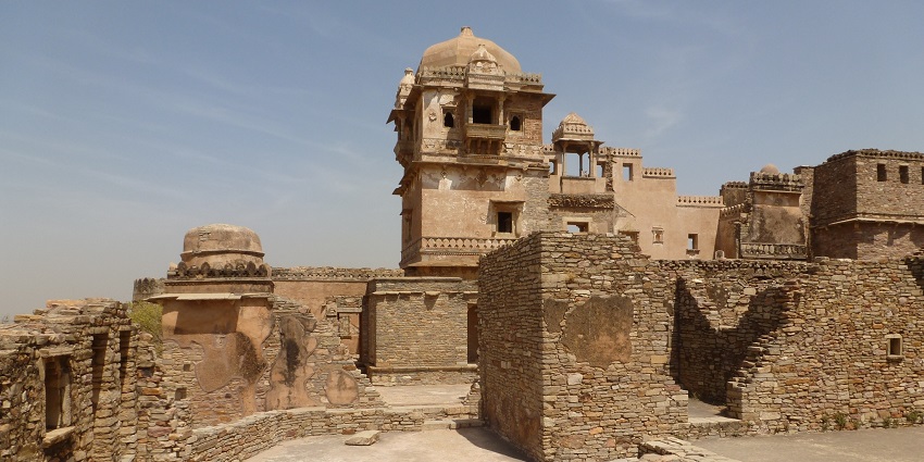 Image of Chittorgarh Fort with fort ruins surrounded by lush greenery and mountains