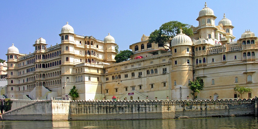 City Palace reflected in the lake, offering a stunning view of top Udaipur tourist places.