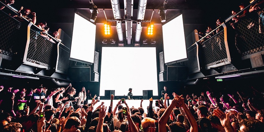 A dynamic DJ set in Bhutan, with energetic revellers enjoying vibrant Thimphu nightlife.