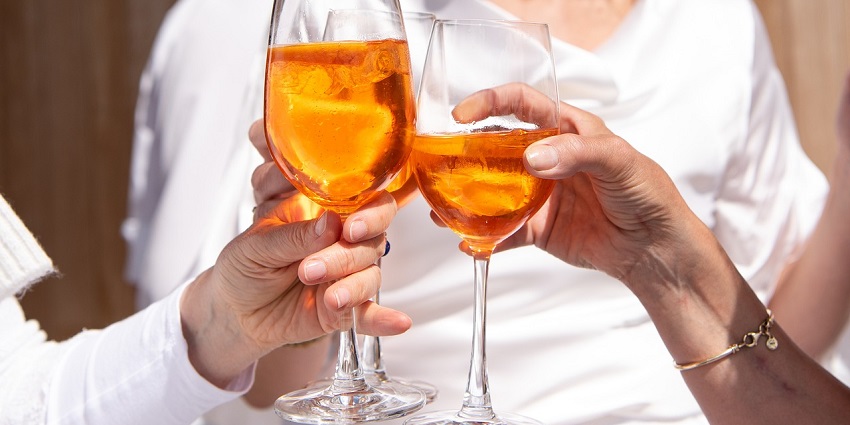 A close-up of glasses with colourful cocktails held by women in their hands at Club Blackout.