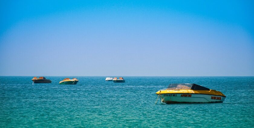 Picturesque view of boat parking at Colva beach under clear blue - Colva beach water sports