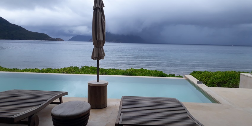 View from Six Senses Resort in Con Dao, displaying a tranquil beach with lush surroundings.