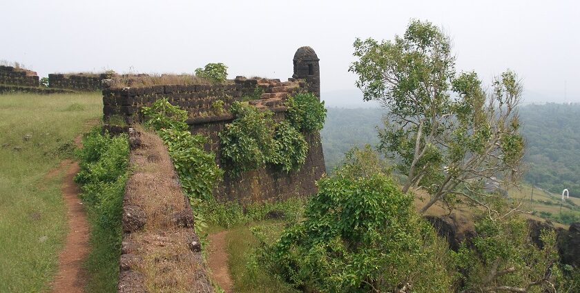 Walls of the Cojuem fort covered with moss and surrounded by lush shrubs