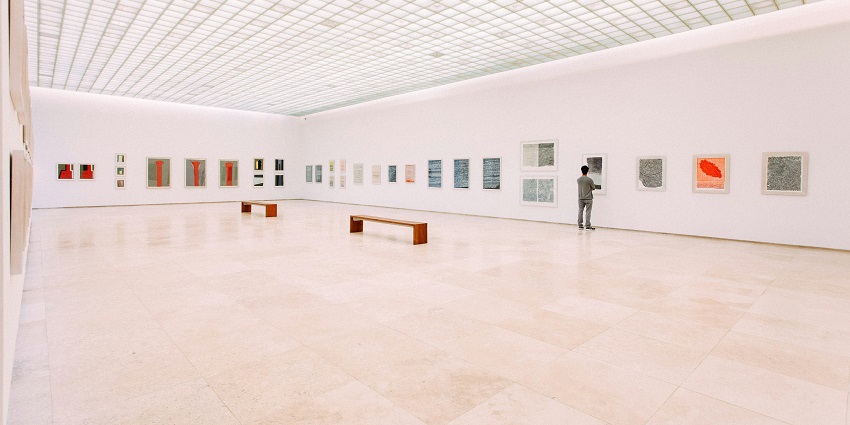An inside view of the Creativity tourist attraction featuring a plethora of paintings.